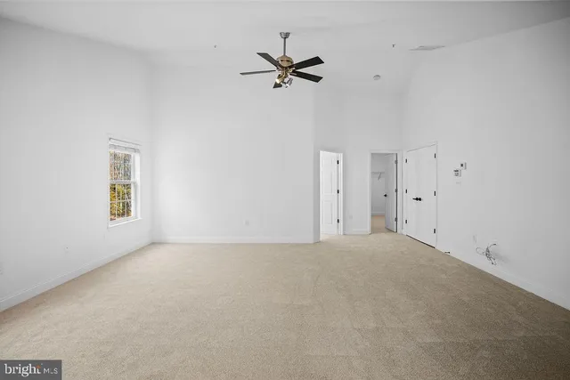 a view of a livingroom with a ceiling fan and window