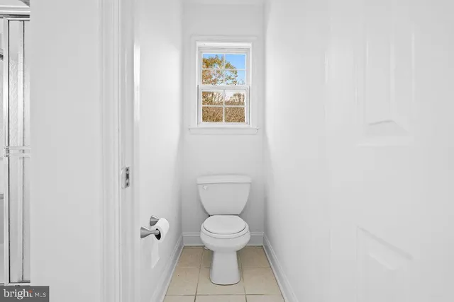 a white toilet sitting next to a bathroom sink