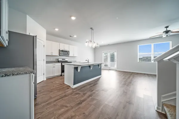 a kitchen with stainless steel appliances a refrigerator sink and cabinets