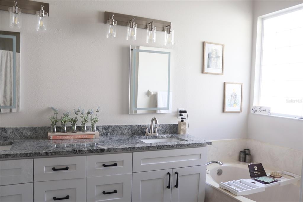 3850 Beacon Ridge Way Clermont, FL 34711 - Photo 26 of 41 a bathroom with a granite countertop sink and a mirror
