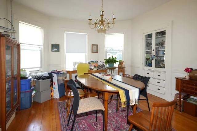 a view of a dining room with furniture and chandelier