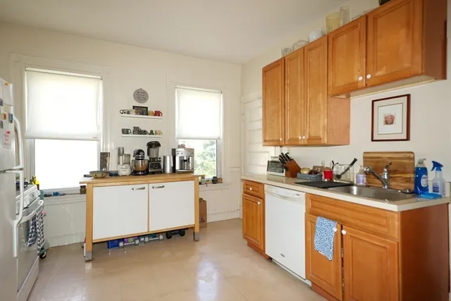 a kitchen with a sink cabinets and window
