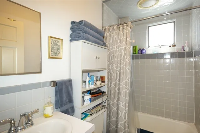 a bathroom with a shower curtain and a sink