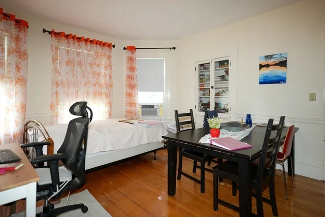 a view of a dining room with furniture and a window