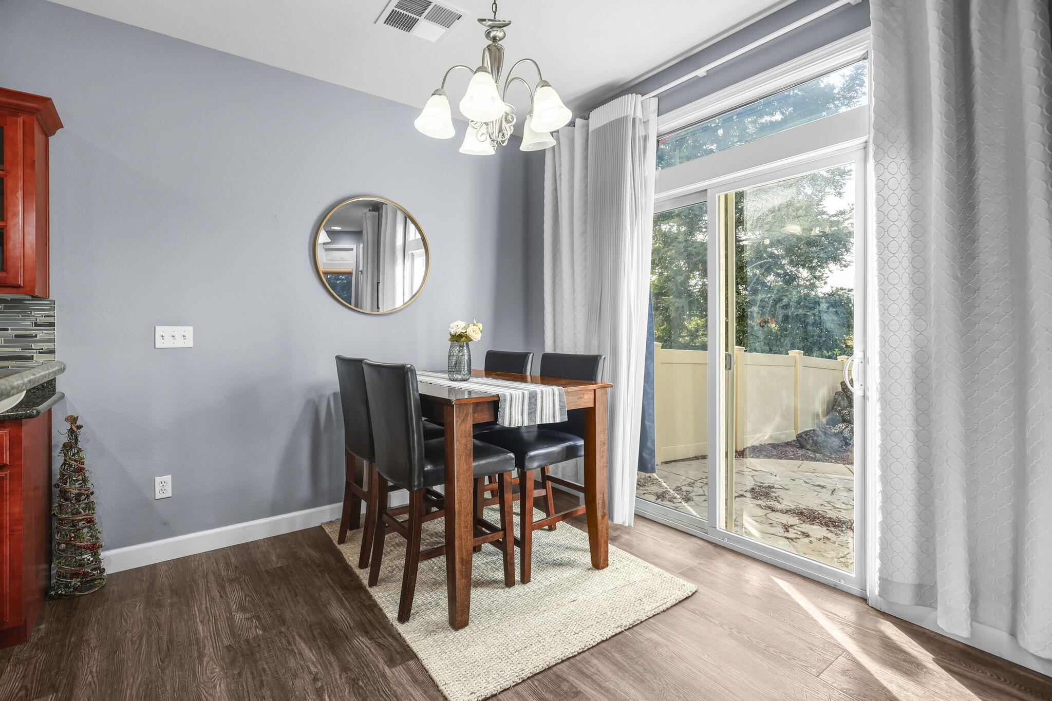 3156 Niklaus Path Redding, CA 96002 - Photo 10 of 34 a view of a dining room with furniture window and wooden floor