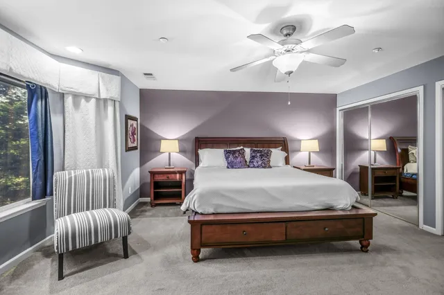 a bedroom with a bed lamp and window