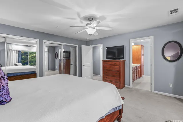 a spacious bedroom with a bed and a chandelier