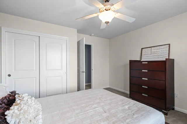 a bedroom with a large bed and a chandelier