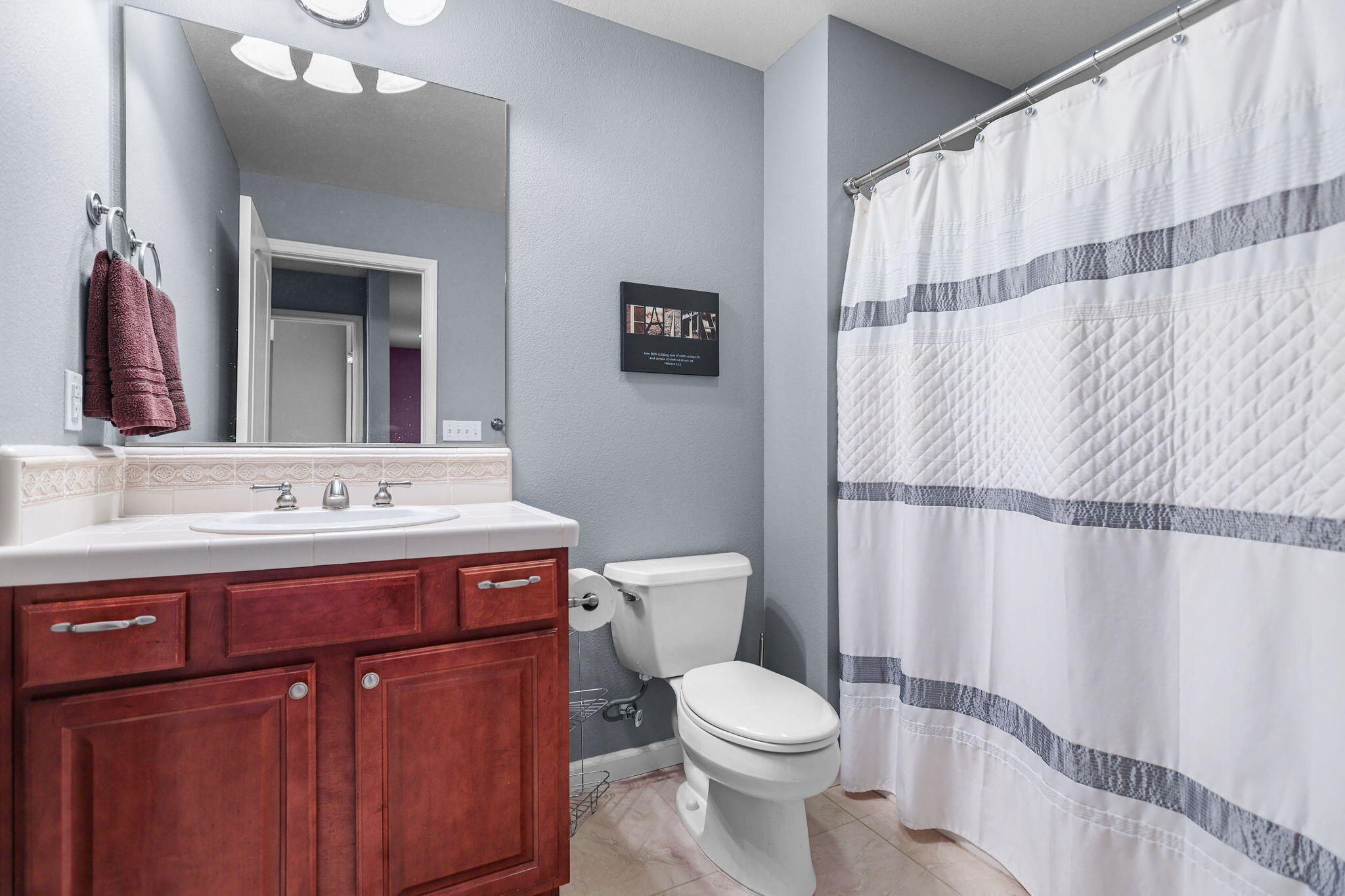 3156 Niklaus Path Redding, CA 96002 - Photo 20 of 34 a bathroom with a sink a toilet and shower curtain