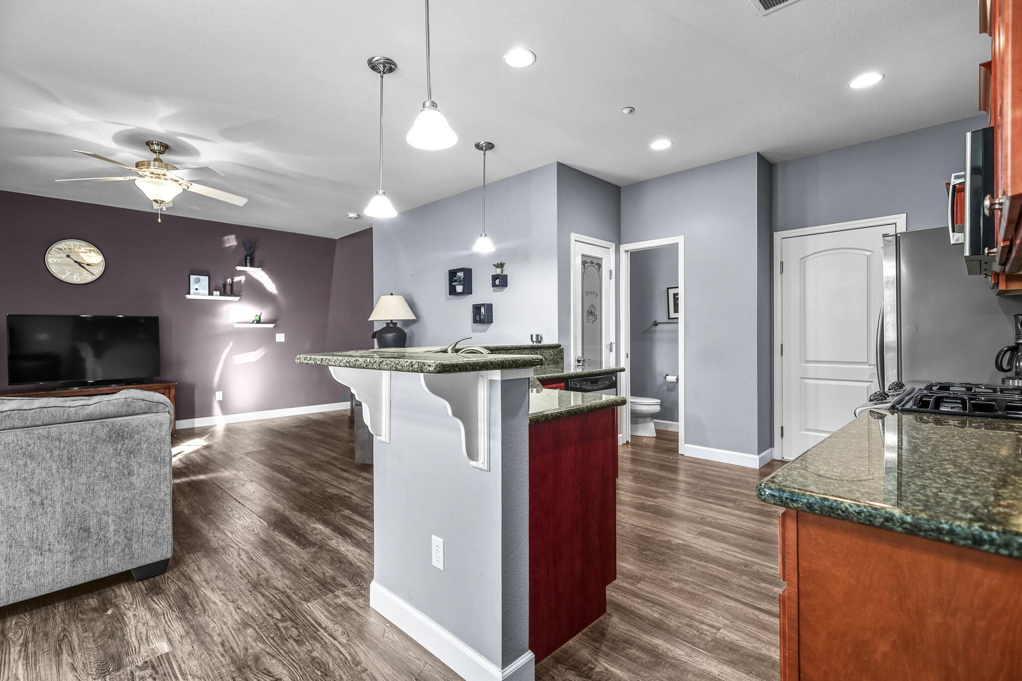 3156 Niklaus Path Redding, CA 96002 - Photo 22 of 34 a kitchen with kitchen island a counter top space a sink and stainless steel appliances