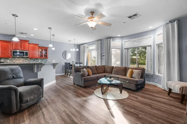 a living room with furniture and a large window