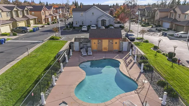 an aerial view of a house with a swimming pool