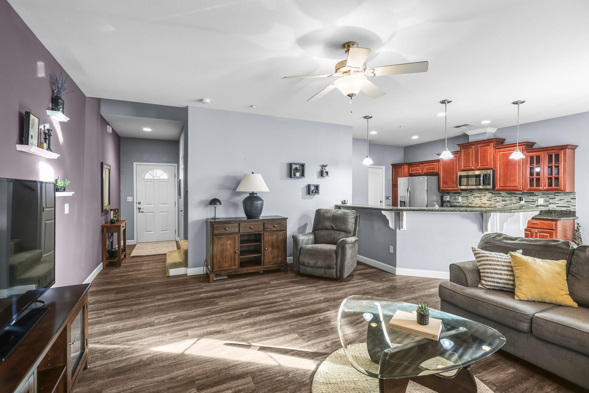 3156 Niklaus Path Redding, CA 96002 - Photo 4 of 34 a living room with furniture kitchen view and a flat screen tv
