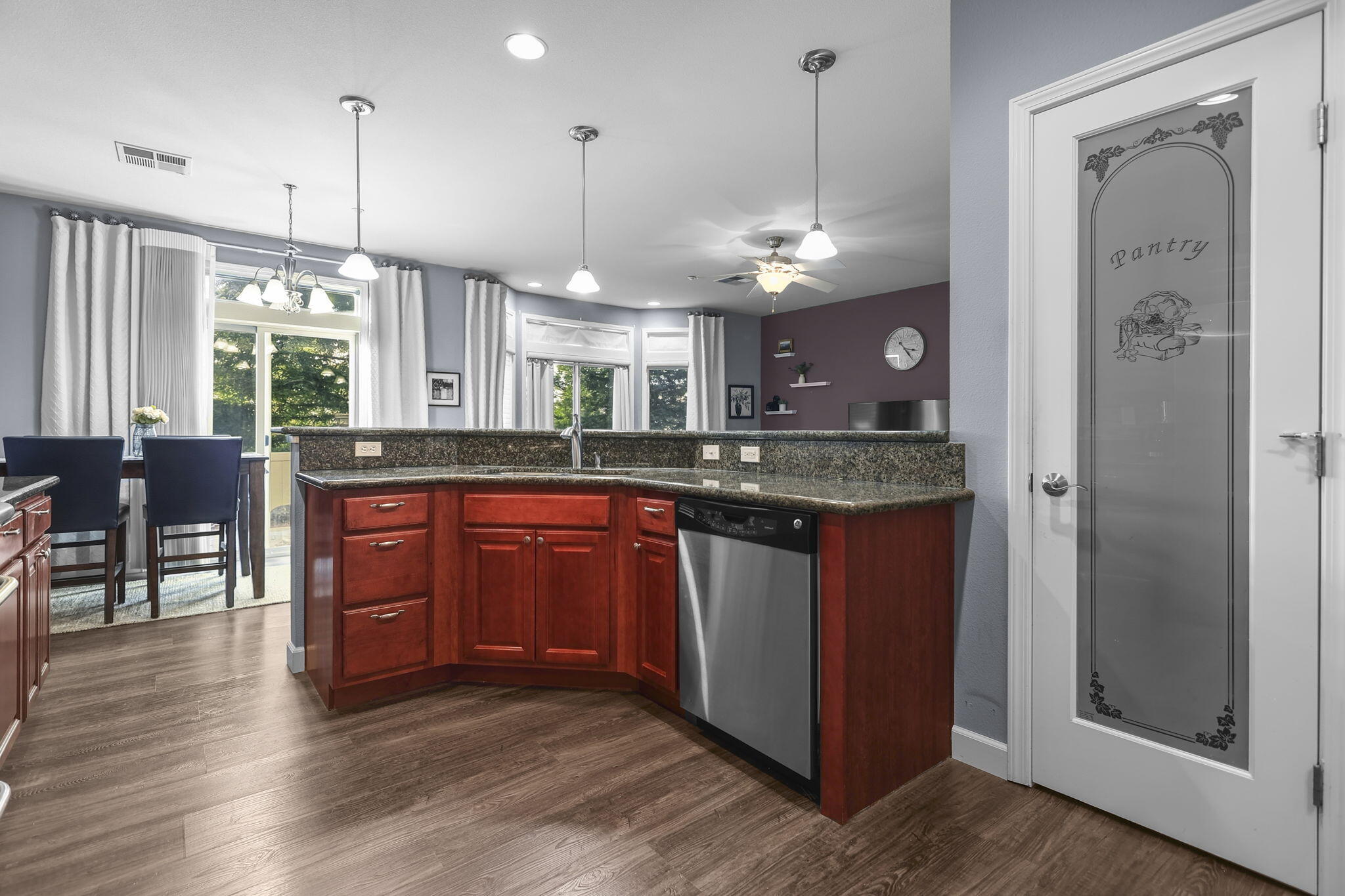 3156 Niklaus Path Redding, CA 96002 - Photo 34 of 34 a kitchen with a refrigerator a sink dishwasher a dining table and chairs