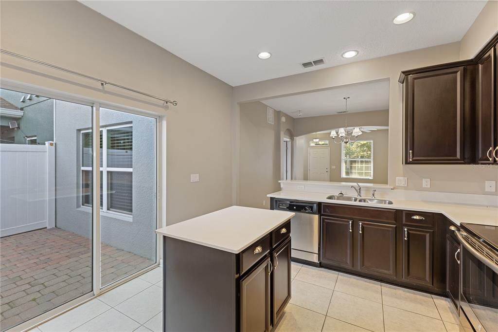506 Rainbow Springs Loop Groveland, FL 34736 - Photo 8 of 30 a kitchen with a sink and chairs