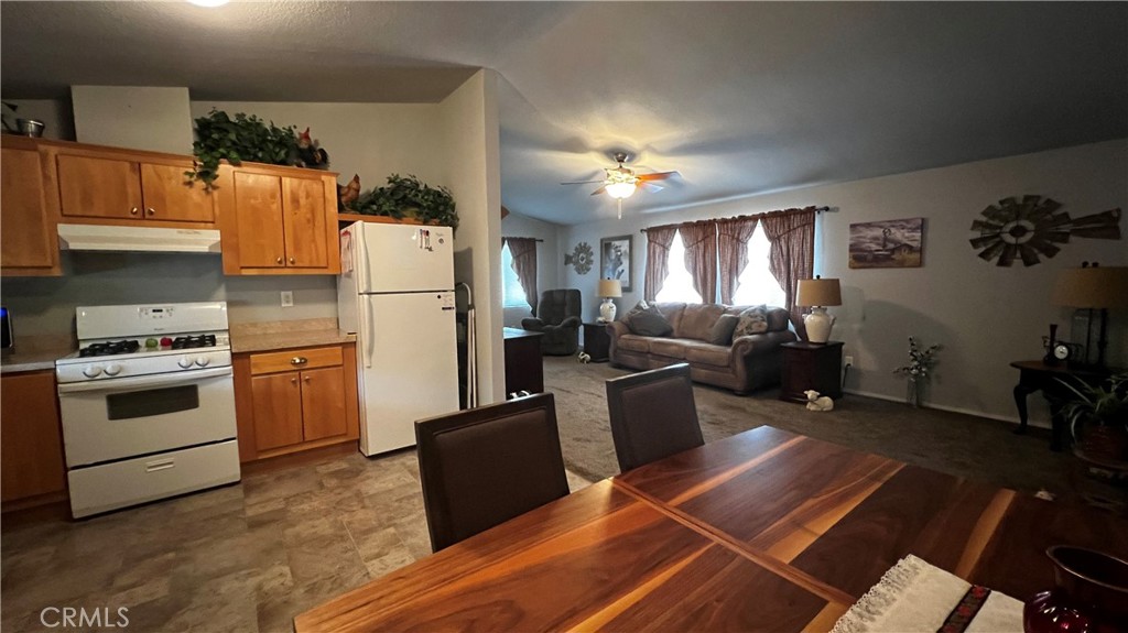 3540 Ebano Way, Unit 187 Chico, CA 95973 - Photo 3 of 3 a kitchen with granite countertop a refrigerator stove and sink