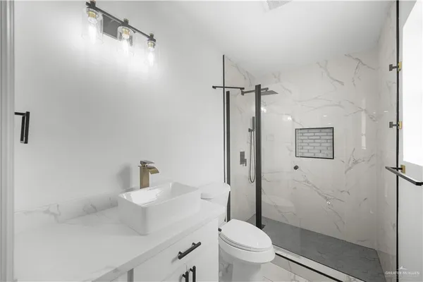 a bathroom with a sink toilet and shower