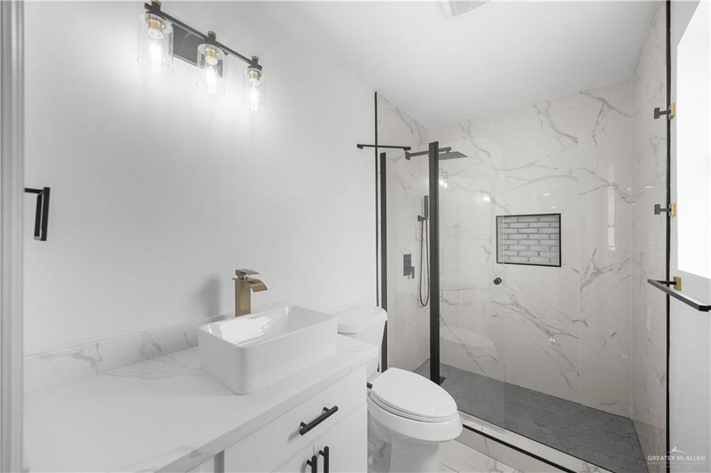 313 West Eller Avenue Pharr, TX 78577 - Photo 11 of 15 a bathroom with a sink toilet and shower