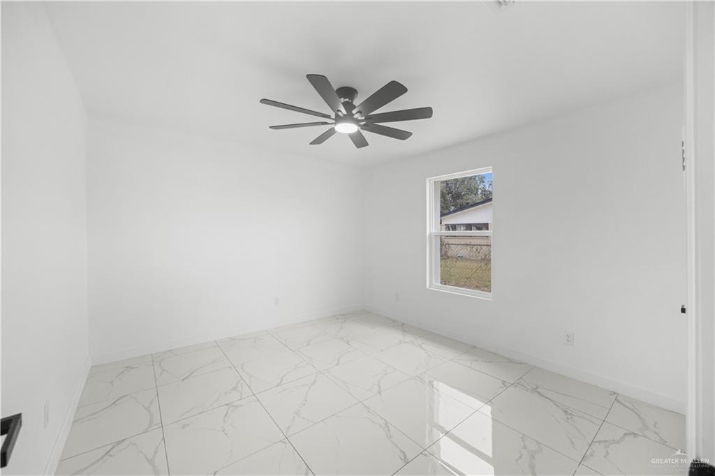 313 West Eller Avenue Pharr, TX 78577 - Photo 8 of 15 an empty room with a window and a ceiling fan