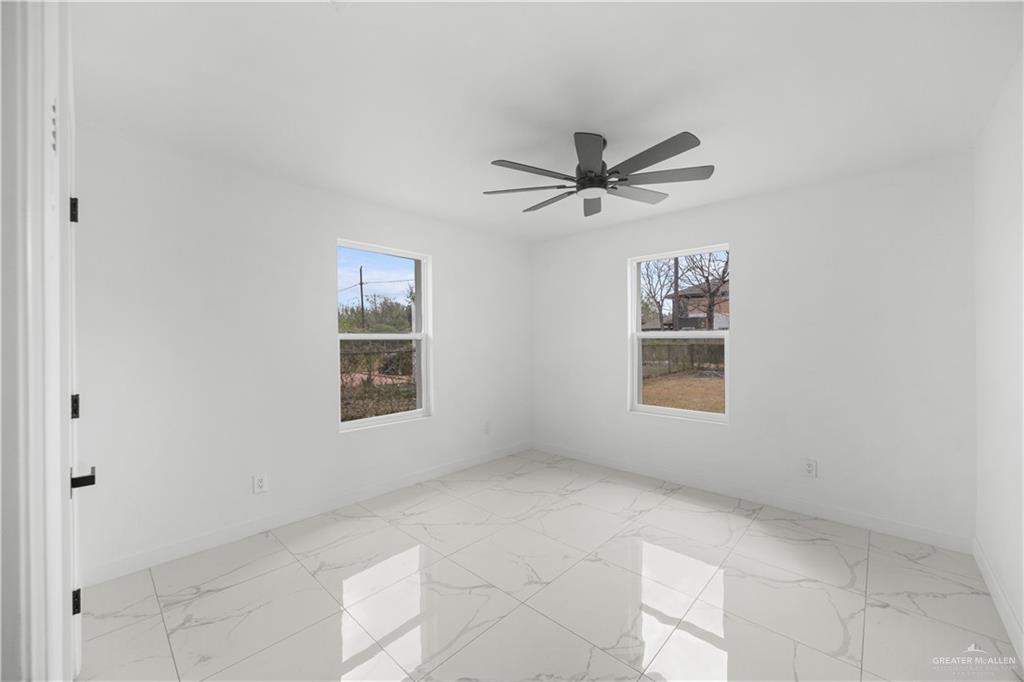 313 West Eller Avenue Pharr, TX 78577 - Photo 9 of 15 a view of a big room with windows and chandelier fan
