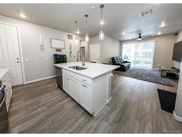 a kitchen with a sink a stove a refrigerator and a microwave