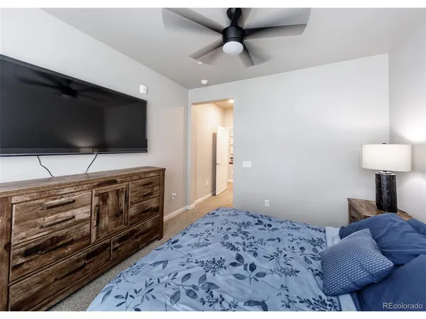 a bedroom with furniture and flat screen tv