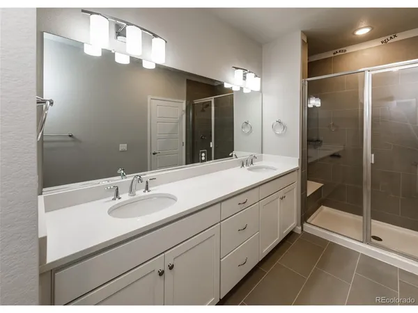 a bathroom with a double vanity sink mirror and double