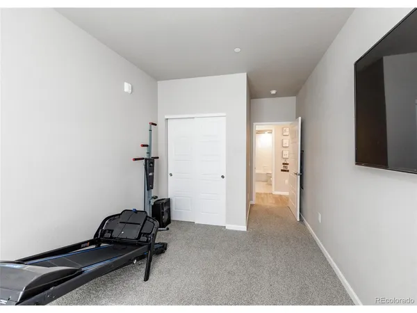a room with gym equipment and a shower