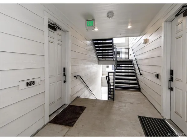 a view of entryway with stairs and a rug