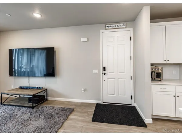 a living room with a rug and a stove