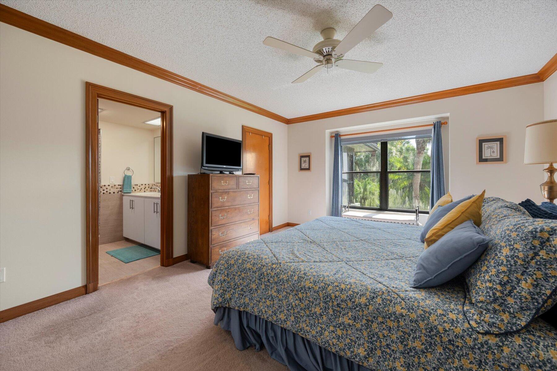 13244 Polo Club Road, Unit C207 Wellington, FL 33414 - Photo 13 of 31 a bed room with a bed and a television