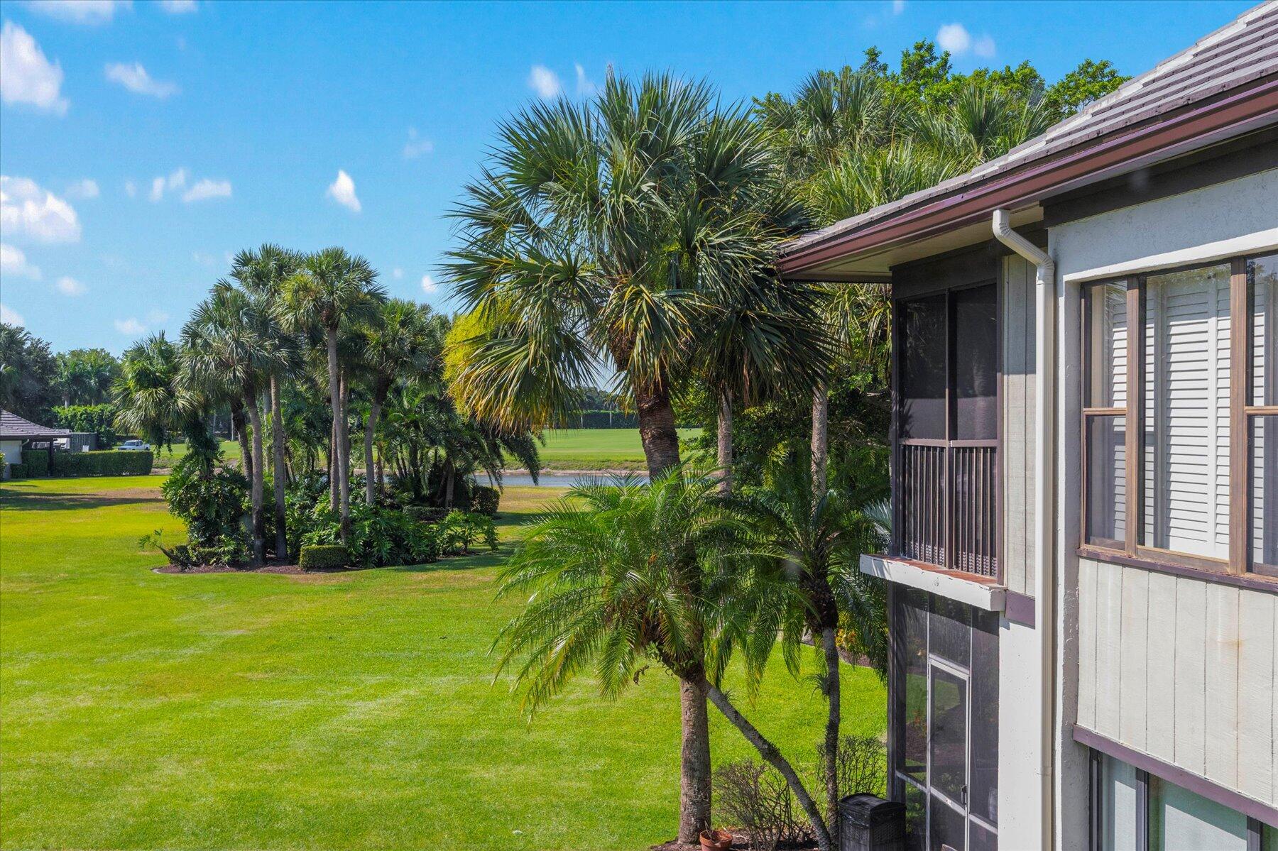 13244 Polo Club Road, Unit C207 Wellington, FL 33414 - Photo 20 of 31 a view of a house with a palm trees