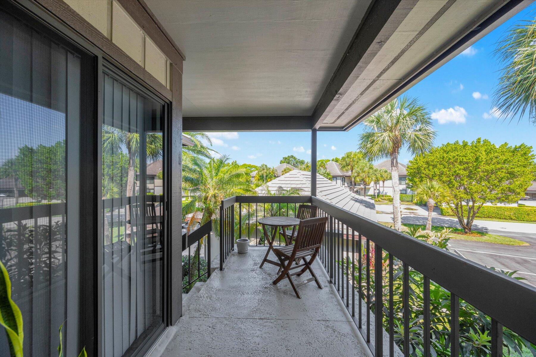 13244 Polo Club Road, Unit C207 Wellington, FL 33414 - Photo 21 of 31 a view of a porch with wooden floor and furniture