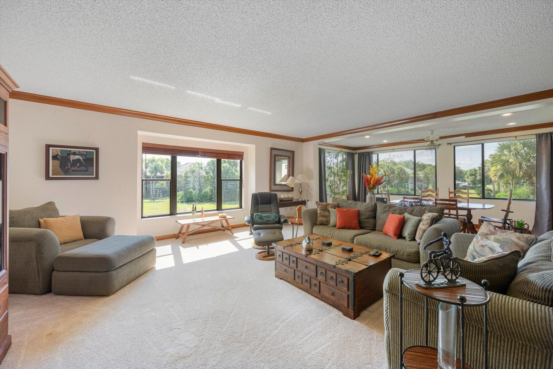 13244 Polo Club Road, Unit C207 Wellington, FL 33414 - Photo 29 of 31 a living room with furniture and a large window