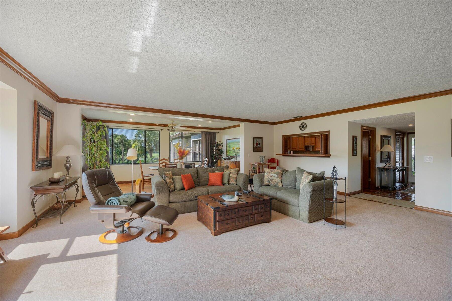 13244 Polo Club Road, Unit C207 Wellington, FL 33414 - Photo 30 of 31 a living room with furniture and a flat screen tv
