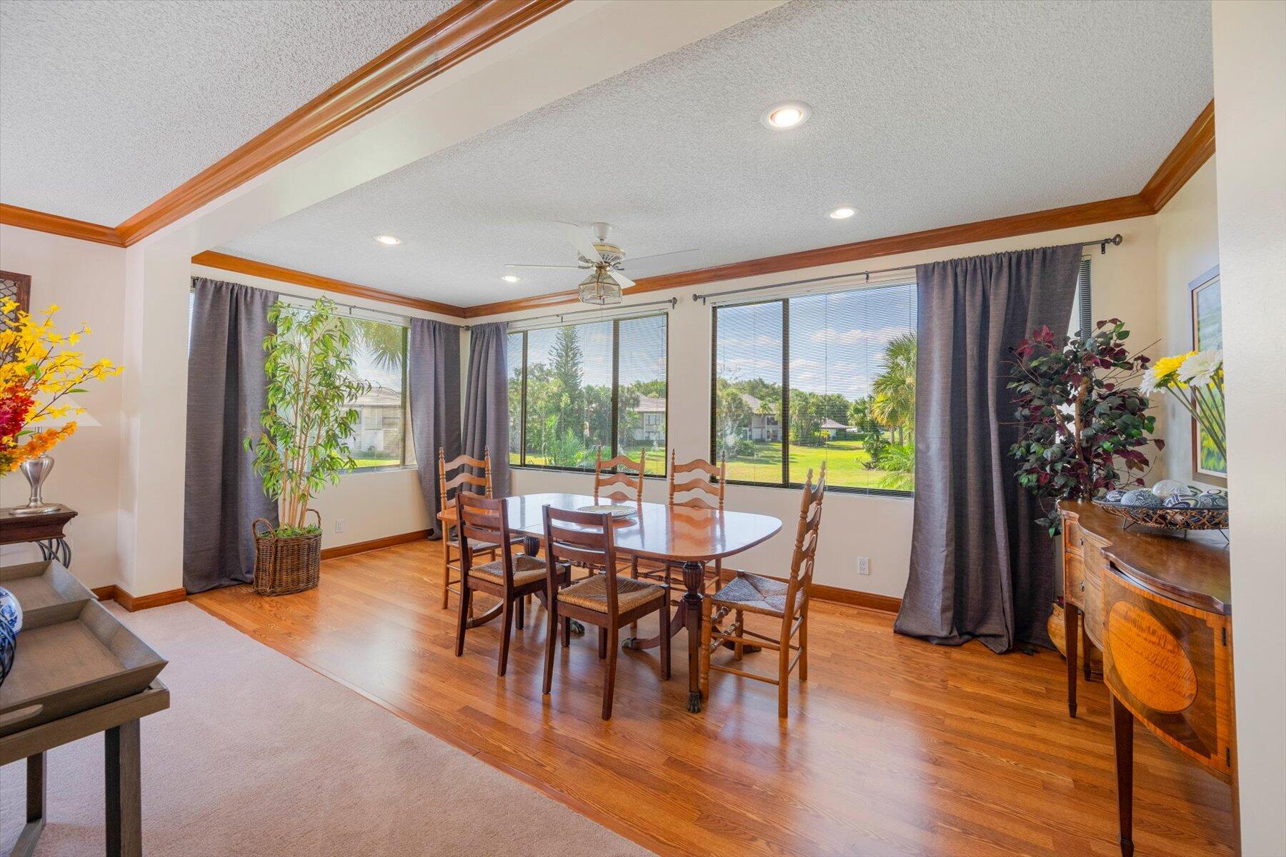 13244 Polo Club Road, Unit C207 Wellington, FL 33414 - Photo 3 of 31 a view of a dining room with furniture window and wooden floor