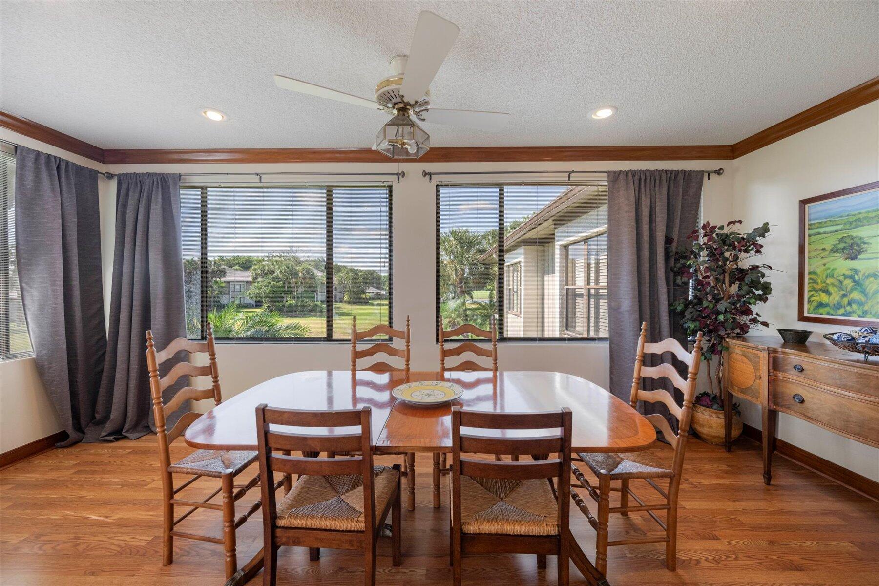 13244 Polo Club Road, Unit C207 Wellington, FL 33414 - Photo 4 of 31 a dining room with furniture a chandelier and wooden floor