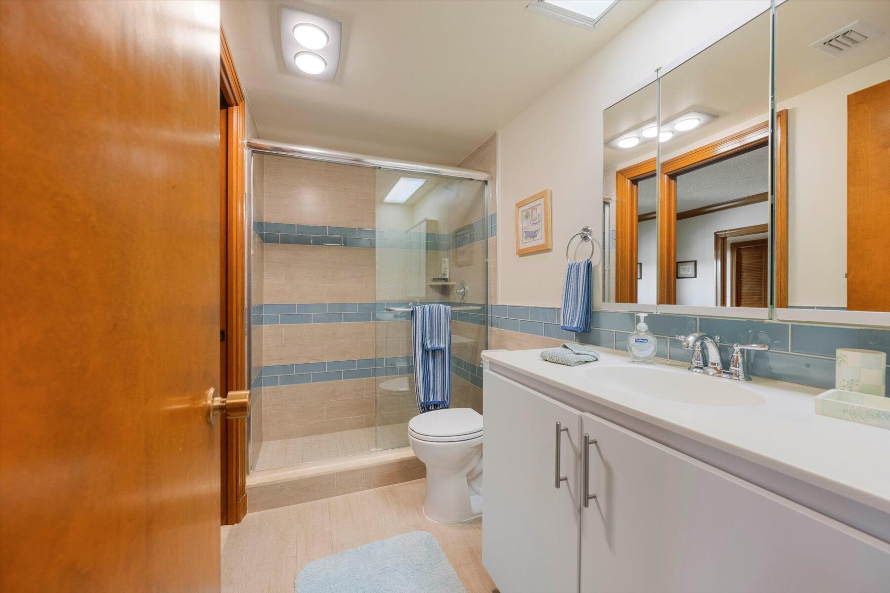 13244 Polo Club Road, Unit C207 Wellington, FL 33414 - Photo 10 of 31 a bathroom with a sink a toilet and a mirror