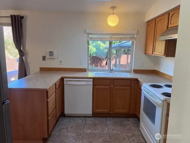 a kitchen with a sink stove and microwave