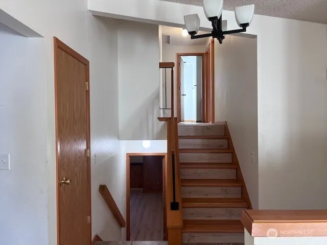 a view of entryway and hall with wooden floor