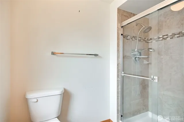 a bathroom with a toilet and a shower