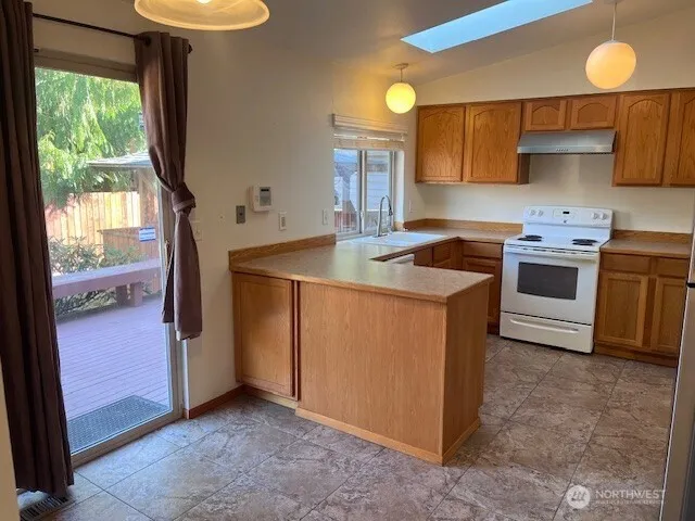 a kitchen that has a sink and a stove