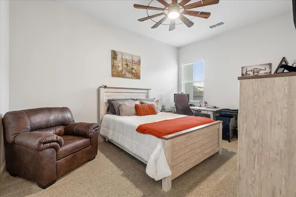 a bedroom with a bed couch and window
