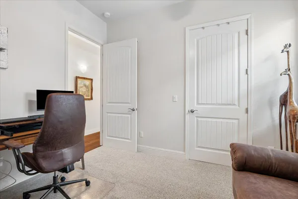 a view of workspace with furniture and a closet