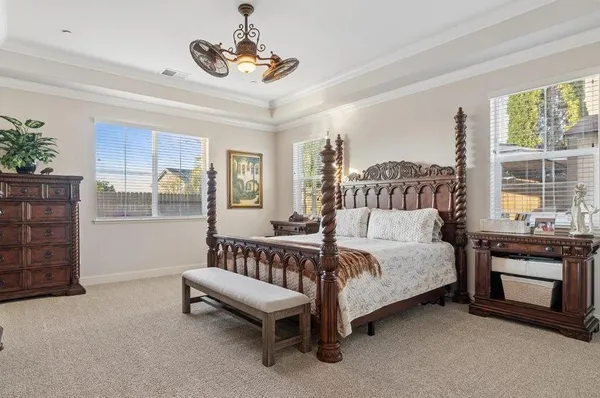 a bedroom with a bed and a chandelier