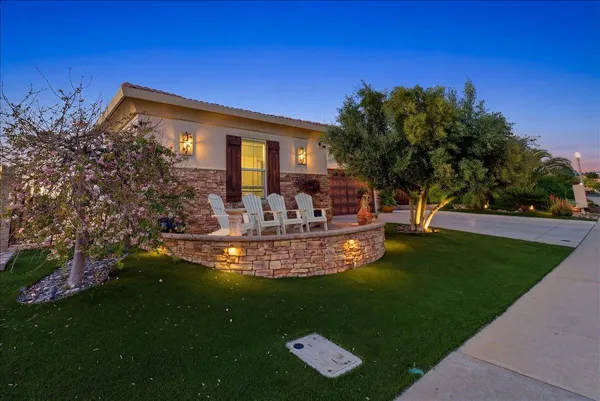 a view of a house with backyard and sitting area