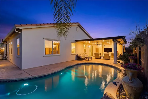 a swimming pool with lawn chairs