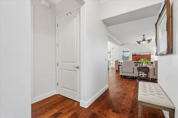 a view of a hallway with workspace and a window
