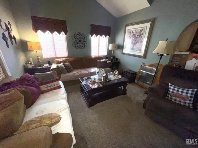 a living room with furniture fireplace and a large mirror