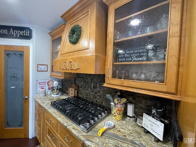 a kitchen with a stove a microwave and cabinets